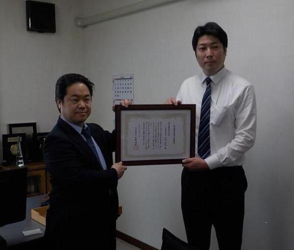 表彰状を掲げる帯広財務事務所長と東洋農機社長