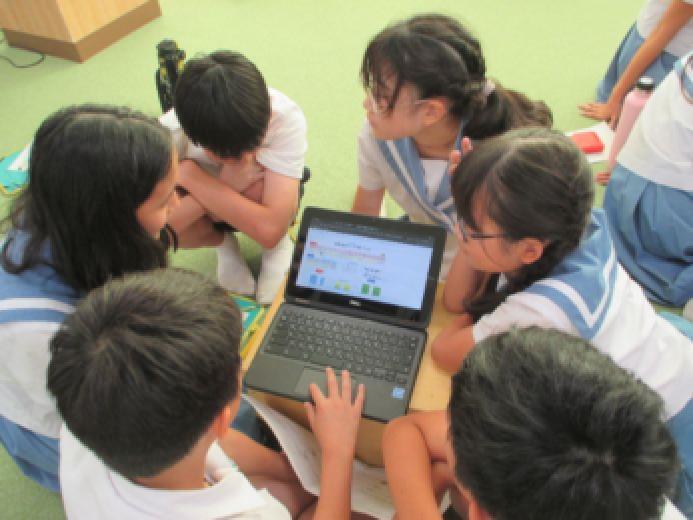生徒がタブレットを用いてグループワークをしている