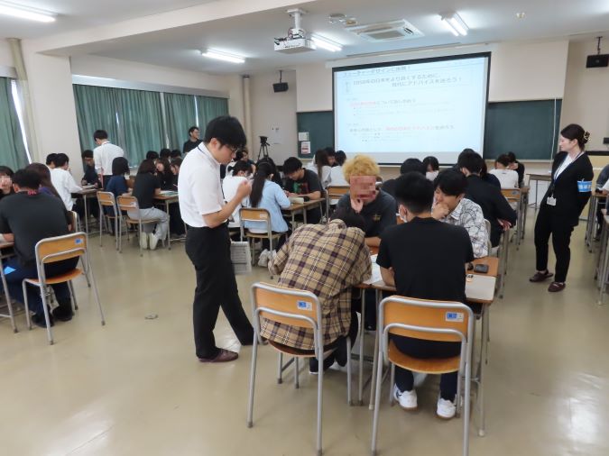 議論する学生たちと見回る講師達